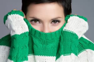 womancoveringmouthsweater